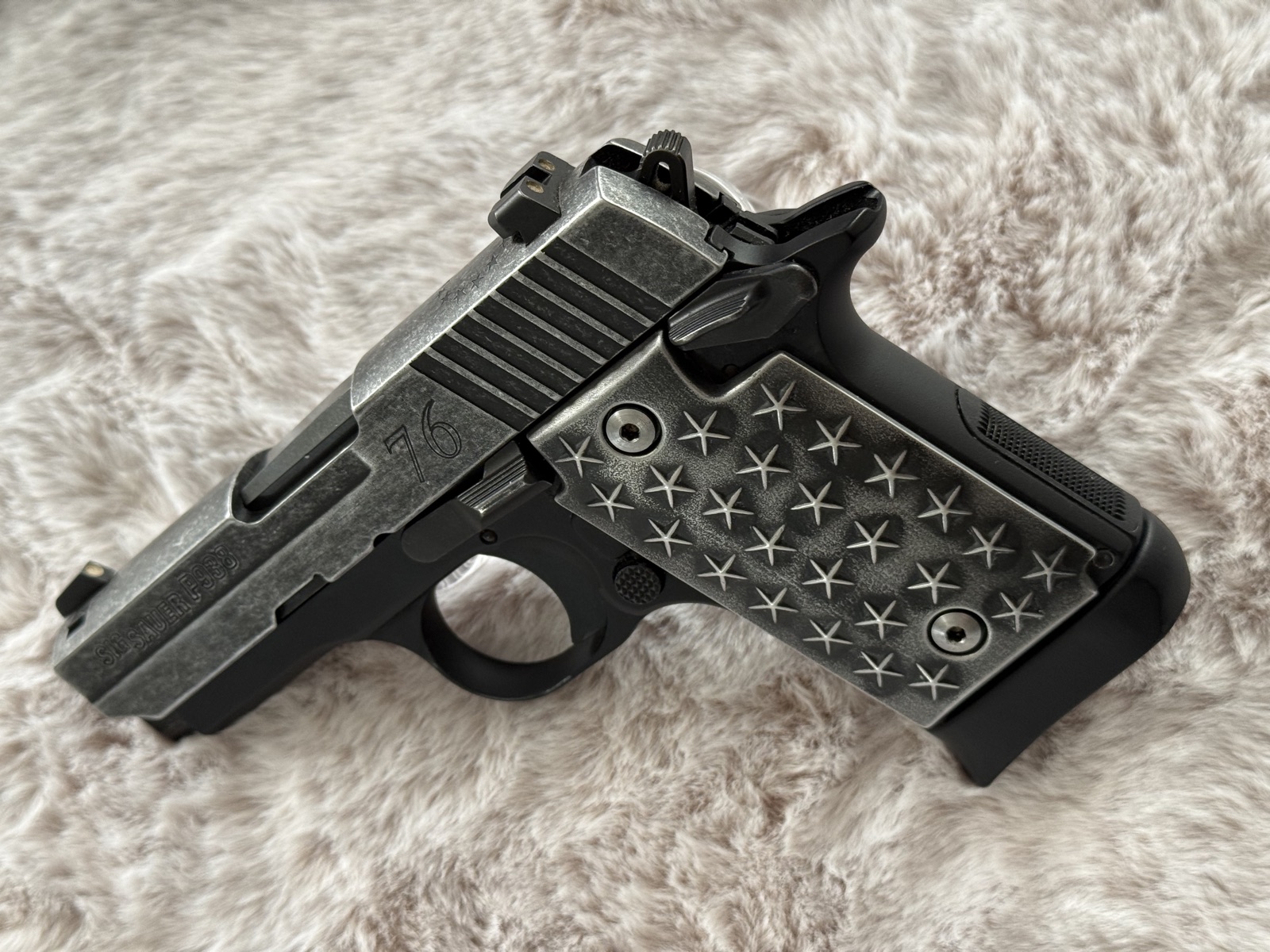 Sig Sauer P938 with restored star-pattern grip panels and distressed We The People Cerakote finish